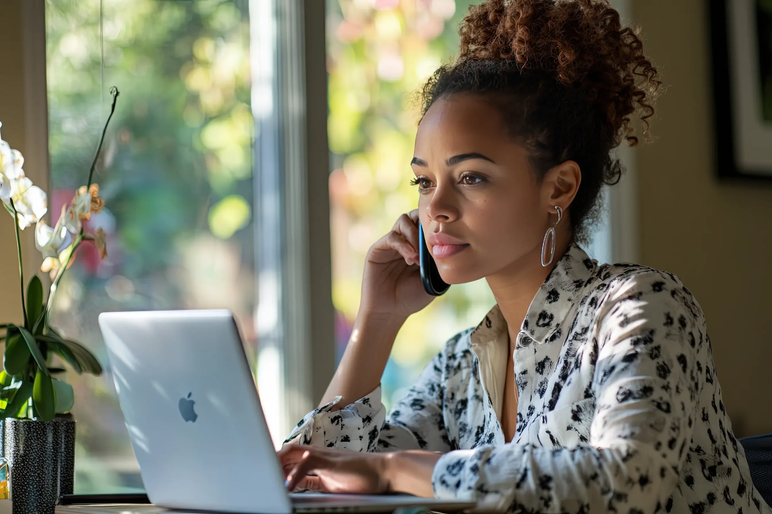 Mom working from home on her side hustle, balancing a phone call and laptop, representing flexible work opportunities for busy moms.